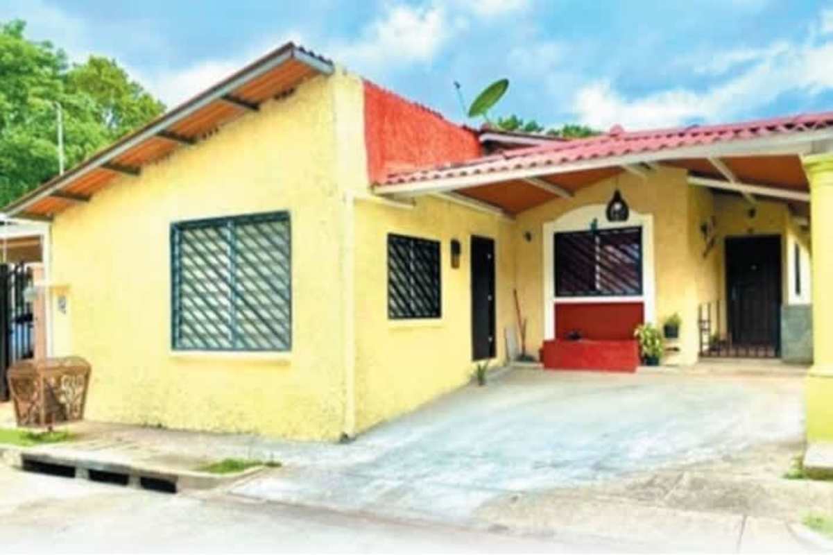 Yellow single-story house with covered porch and driveway in Las Cumbres neighborhood Panama City