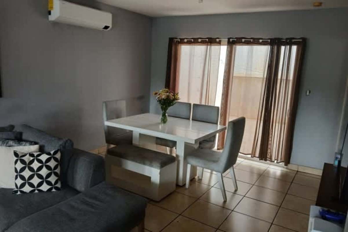 Bright kitchen with stove, cabinets and tiled backsplash in house for sale Brisas del Golf Panama