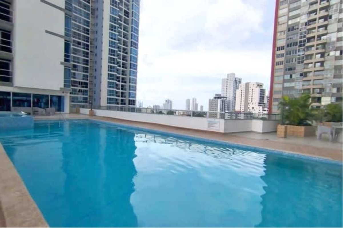 Kitchen with granite counters, breakfast bar and dark cabinets in PH Metropolitan Park apartment Panama
