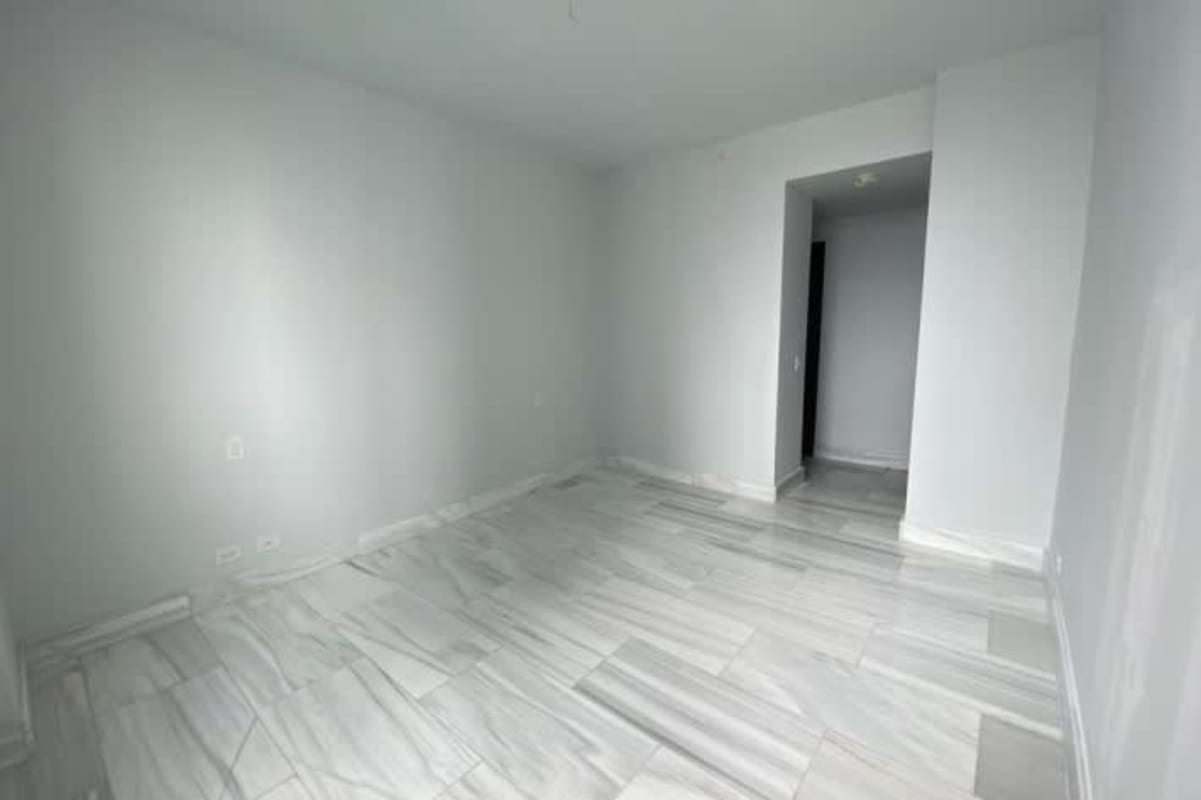 Luxury bathroom with marble walls floors double sinks round mirrors The Towers Punta Paitilla