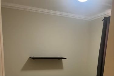 Long tiled hallway with ceiling fan inside modern home La Chorrera Panama