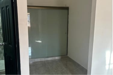 Minimal living space with ceiling fan pendant lights and beige tile floors