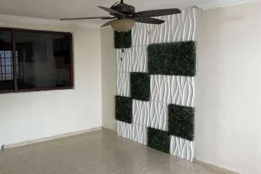 Living room with textured wall panels ceiling fan and lighting modern house Panama