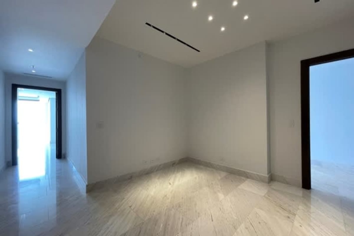 Spacious bedroom with walk-in closet, ocean and skyline view, marble flooring at The Towers Punta Paitilla