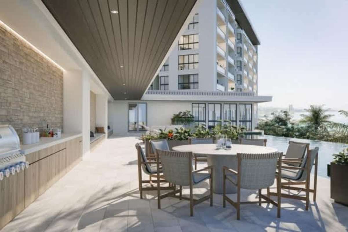 Outdoor BBQ kitchen and dining next to pool at luxury condo Passage Amador Panama