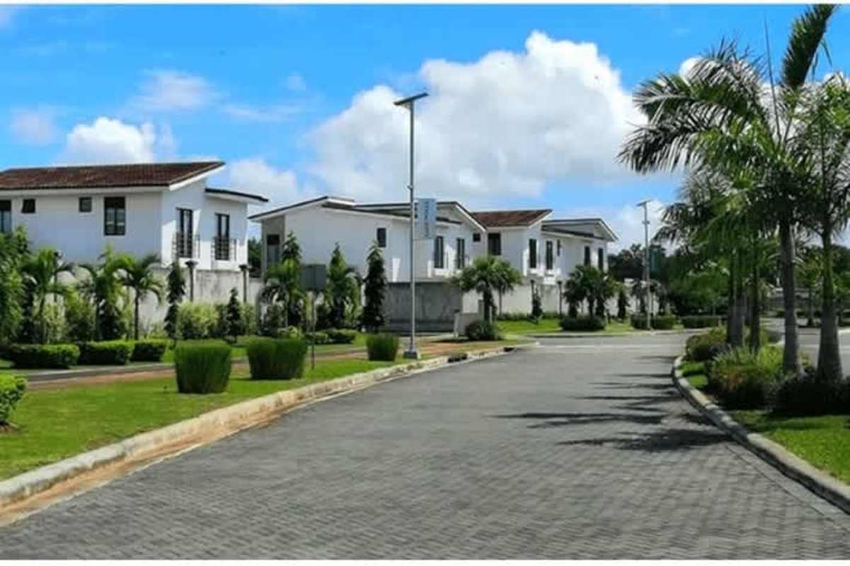 Large community swimming pool with lounge chairs in Costa Sur Panama