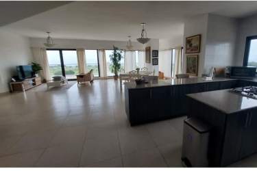 Granite countertop kitchen with center island cooktop and stainless appliances at Vista Mar Golf Beach Resort