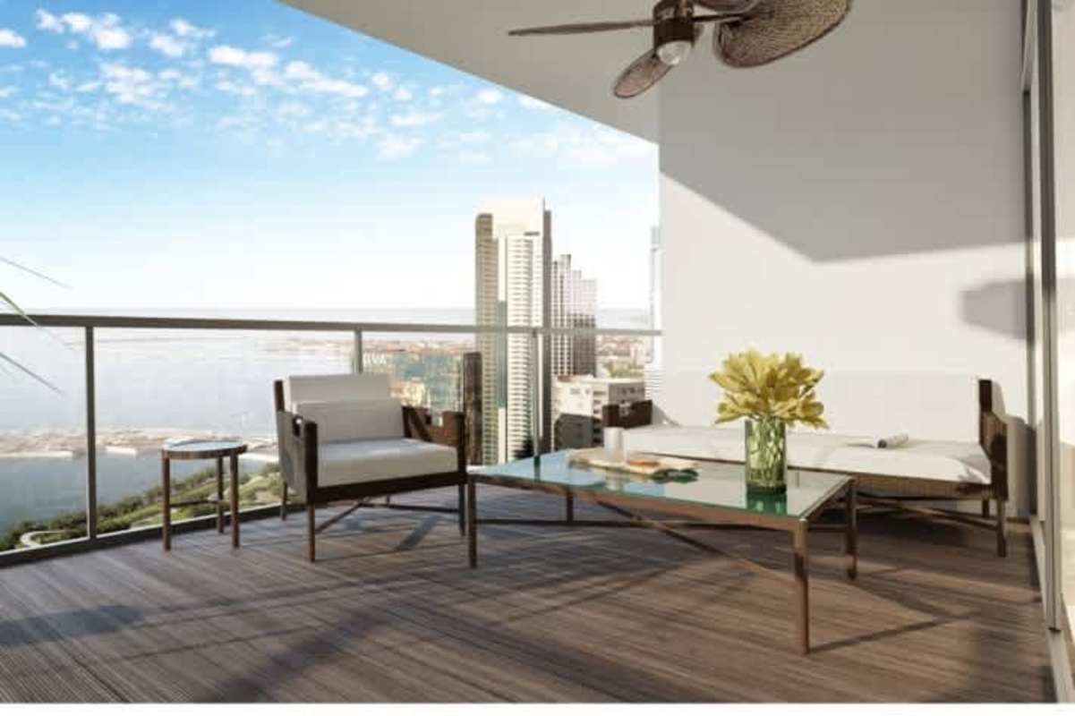 Open-plan living dining space with marble floors, expansive windows, overlooking city skyline