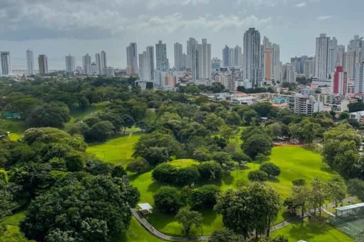 Panoramic aerial overlooking green Parque Omar and Panama City skyline close to Isabella Towers