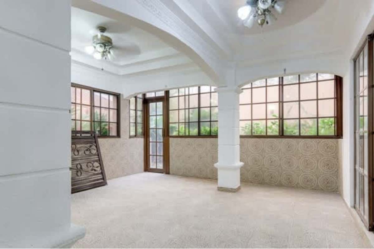 Large community pool with jacuzzi, paved patio, green areas in Versalles Panama