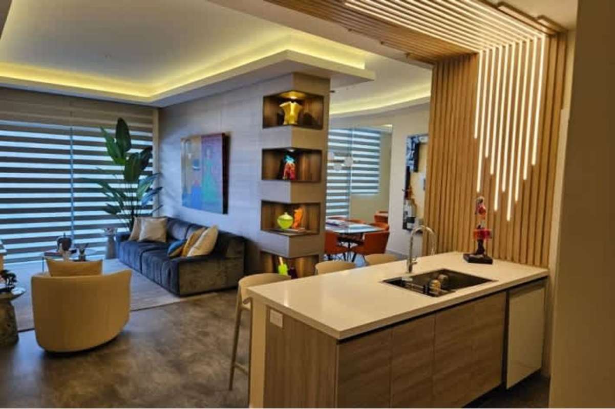 Contemporary dining room with marble table, pendant chandelier and orange chairs in Santa Maria Golf Panama