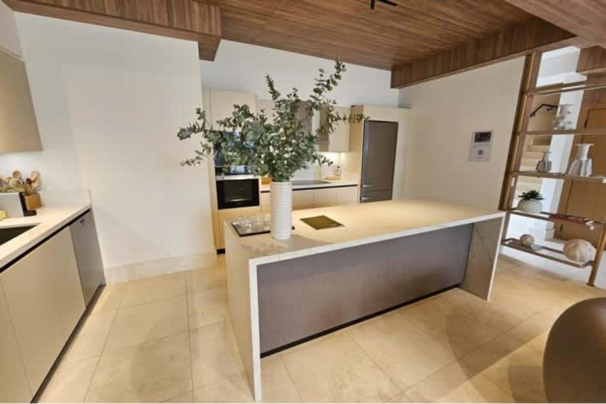 Modern kitchen with granite island, European cabinetry at Ocean Reef Residences Panama