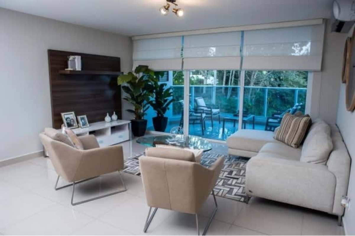 Modern living space with sliding doors facing terrace and pool area at PH Mei Tower Panama