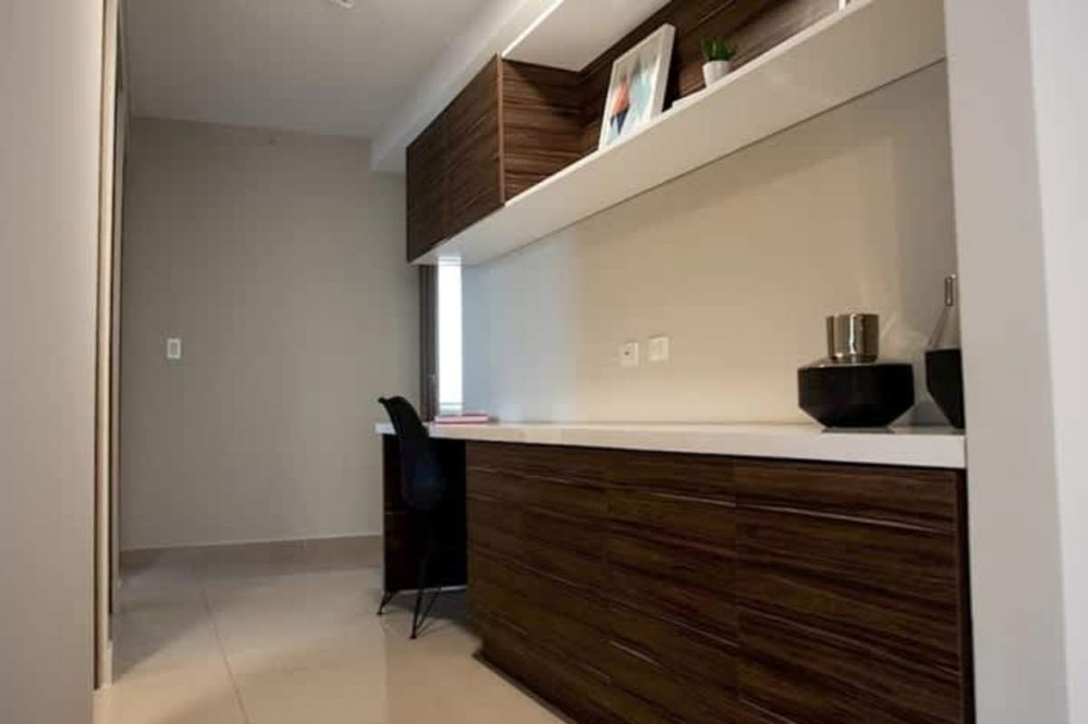 Built-in home office workspace with shelving inside PH Mei Tower Panama City apartment