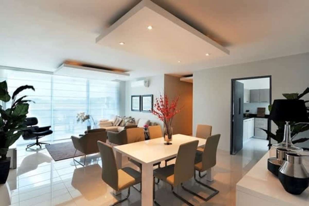 Bright open plan dining and living area with large windows at PH Mei Tower Villa de Las Fuentes Panama City