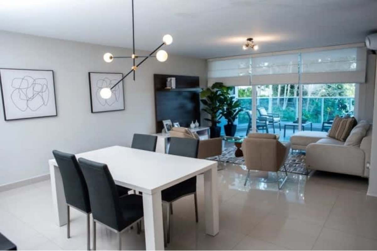 Contemporary living room with large sliding glass doors opening to balcony PH Mei Tower Panama City