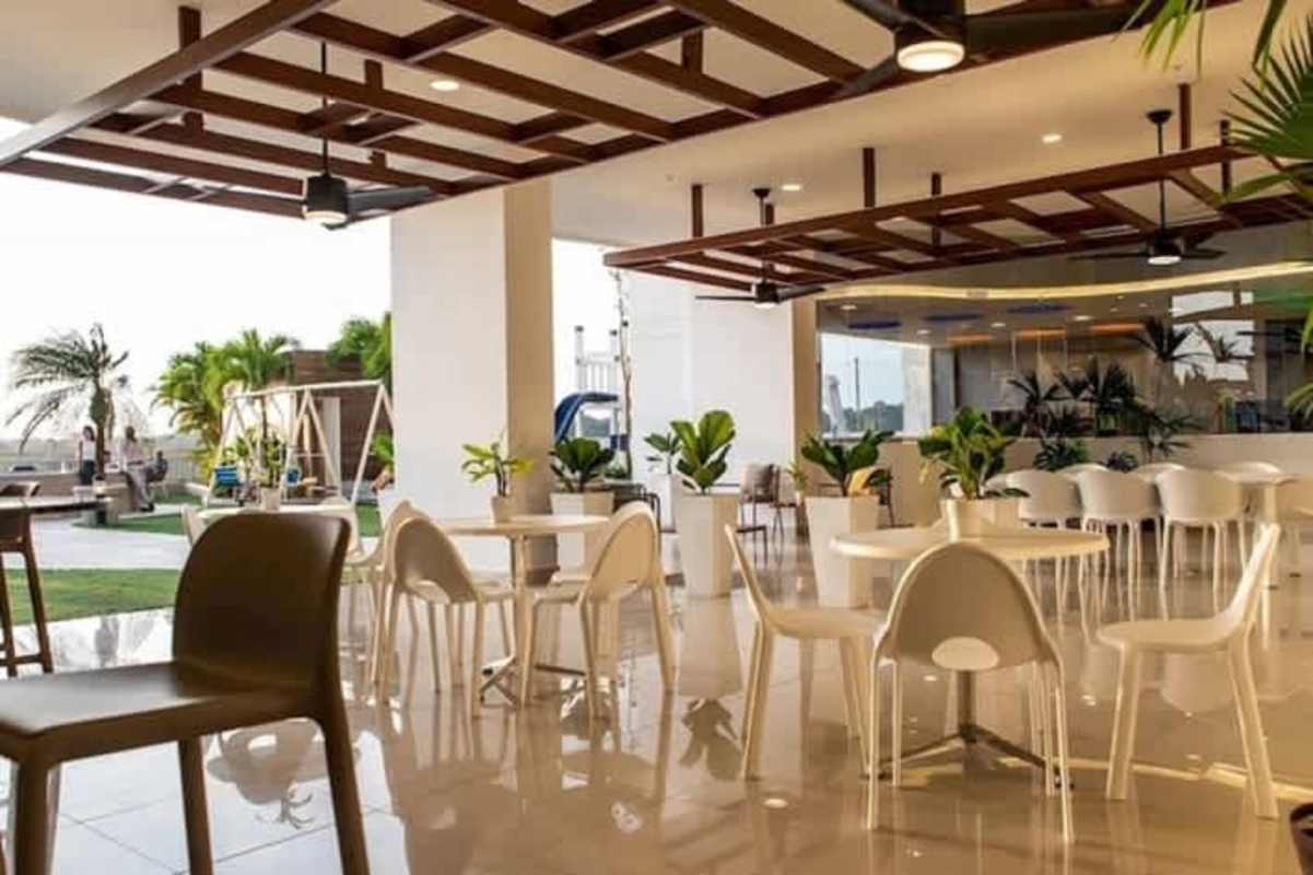 Modern lounge corner with chair, art and side table PH Mei Tower Villa de Las Fuentes Panama City