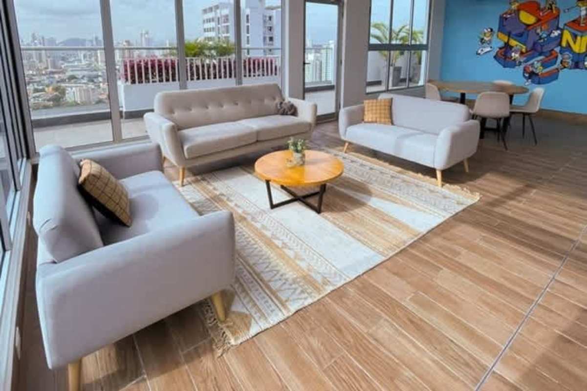 New kitchen with wood cabinetry black counters and window PH Isabella Towers Carrasquilla Panama