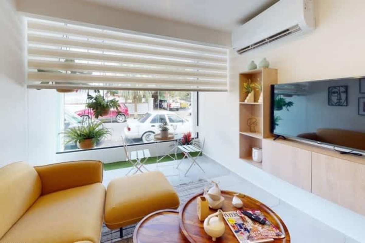 Bright bedroom with large window and city skyline view in Bella Vista Central Panama