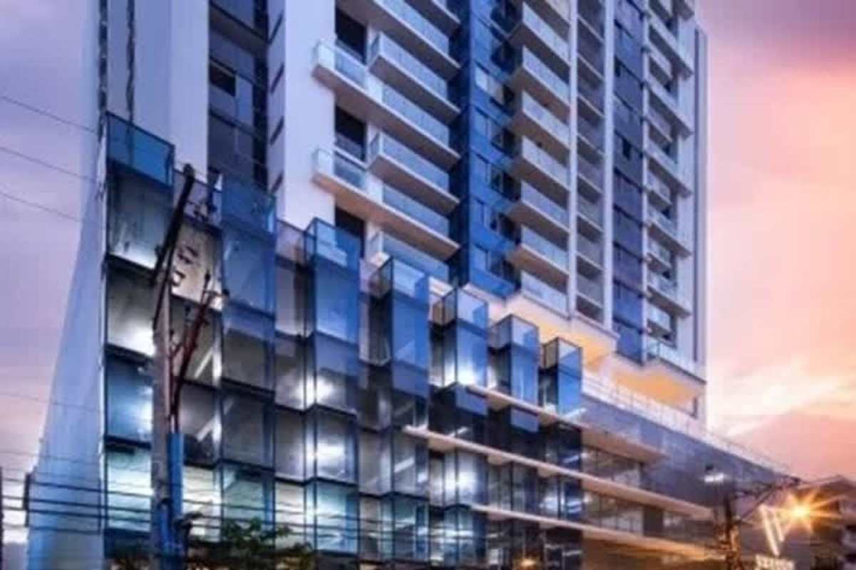 Exterior of PH Velure condominium tower with reflective glass facade in Panama City