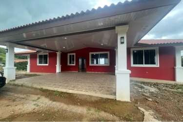 Large kitchen with wooden cabinets, granite countertops and big windows at La Laguna San Carlos country home