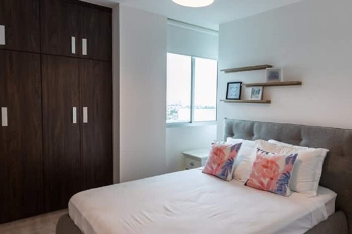 Modern minimalist bedroom built-in wardrobe floor-to-ceiling window Condado Gardens Panama