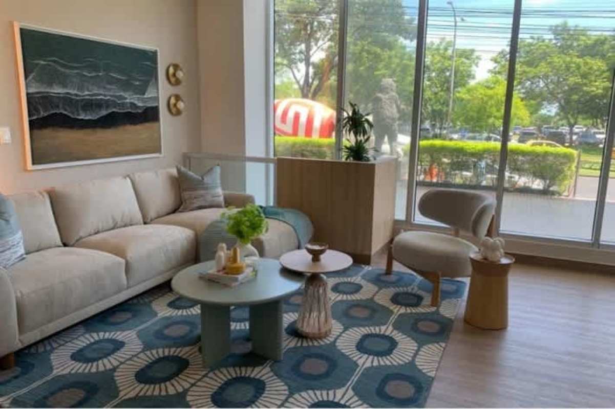 Modern bright living room with large windows and balcony Seaside House Panama City
