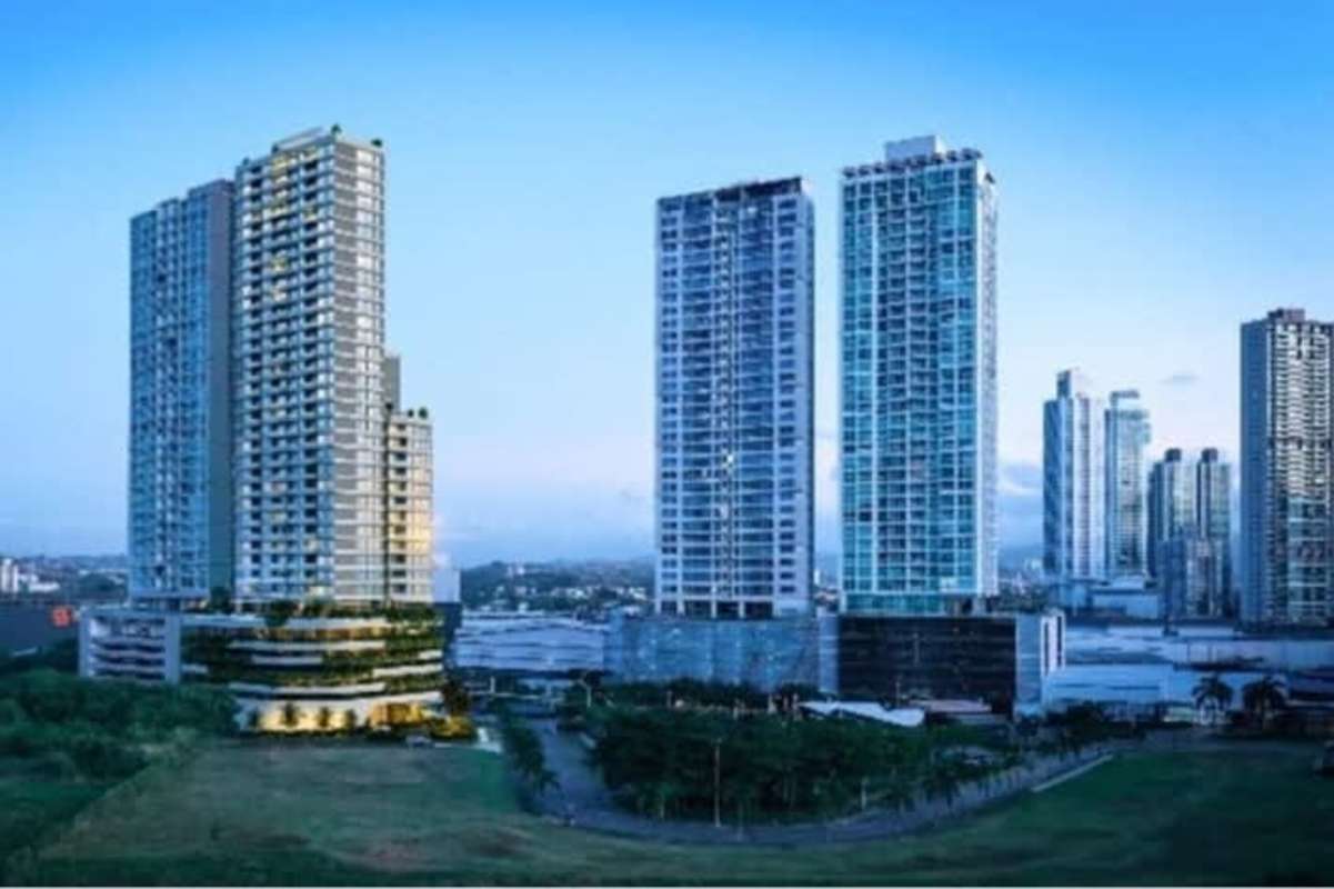 Spacious living room with floor-to-ceiling windows, balcony, city and ocean views at PH Kai