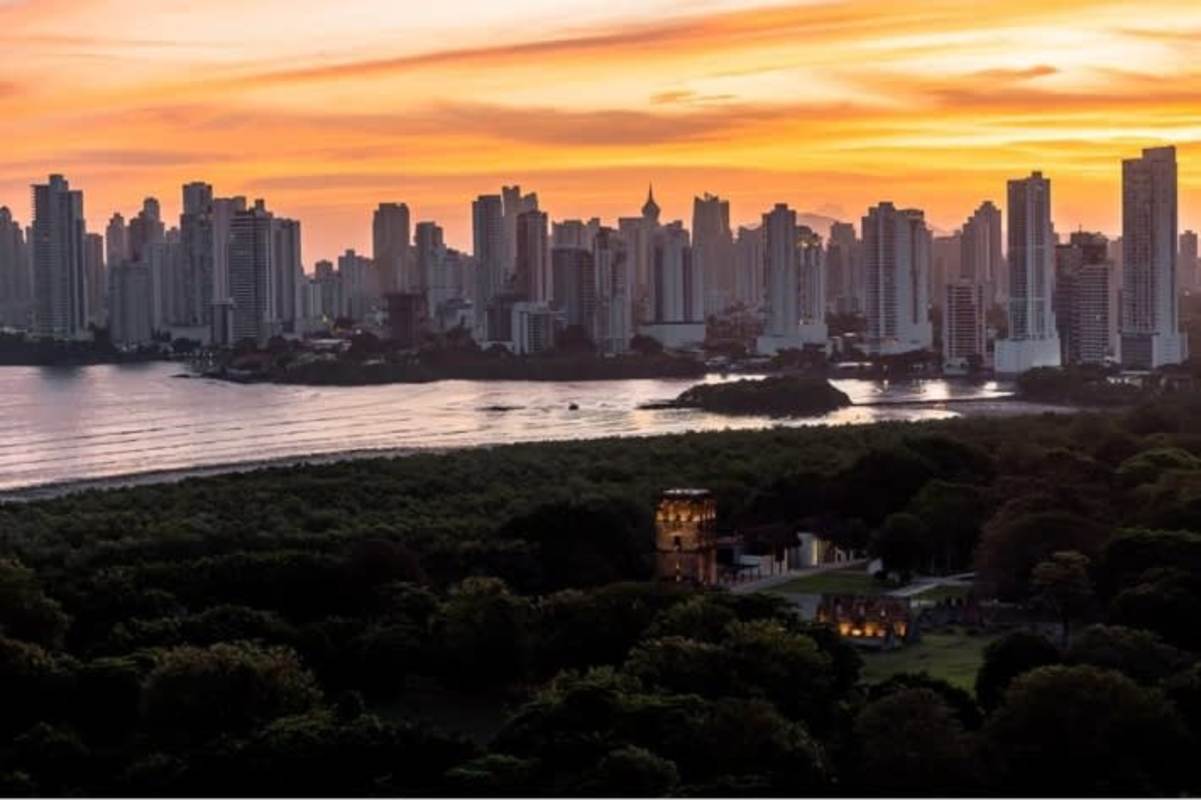 Aerial sunset view of Panama City coastal skyline and lush parks seen from Costa del Este
