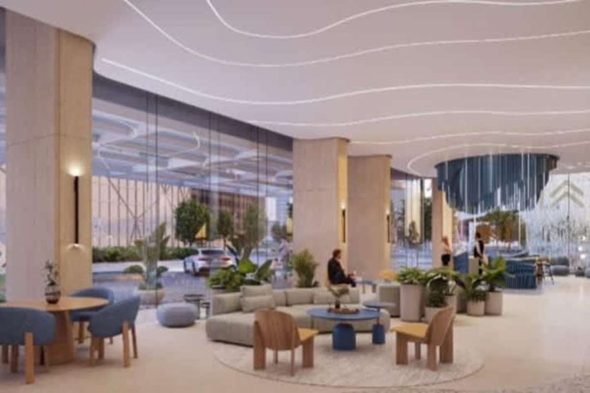 Modern infinity pool surrounded by tropical landscaping overlooking city skyline at PH Kai