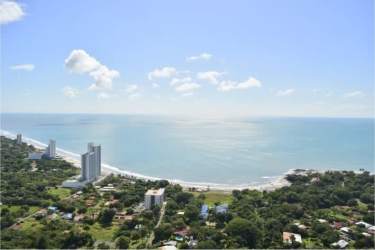 Aerial photo of Playa Gorgona sandy beach with twin towers and surrounding green mountains Panama