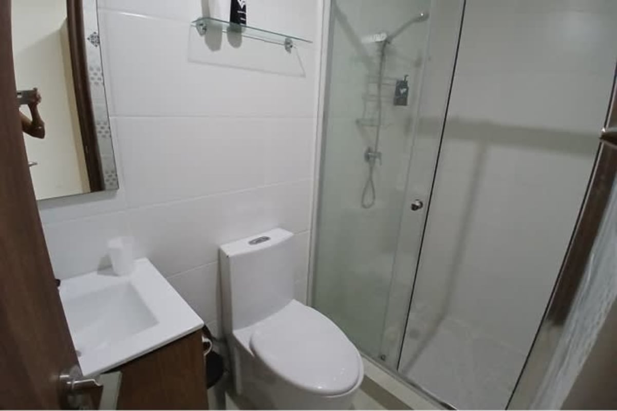 Contemporary bathroom with glass shower enclosure and ceramic sink in PH Torre Bella Vista Panama City