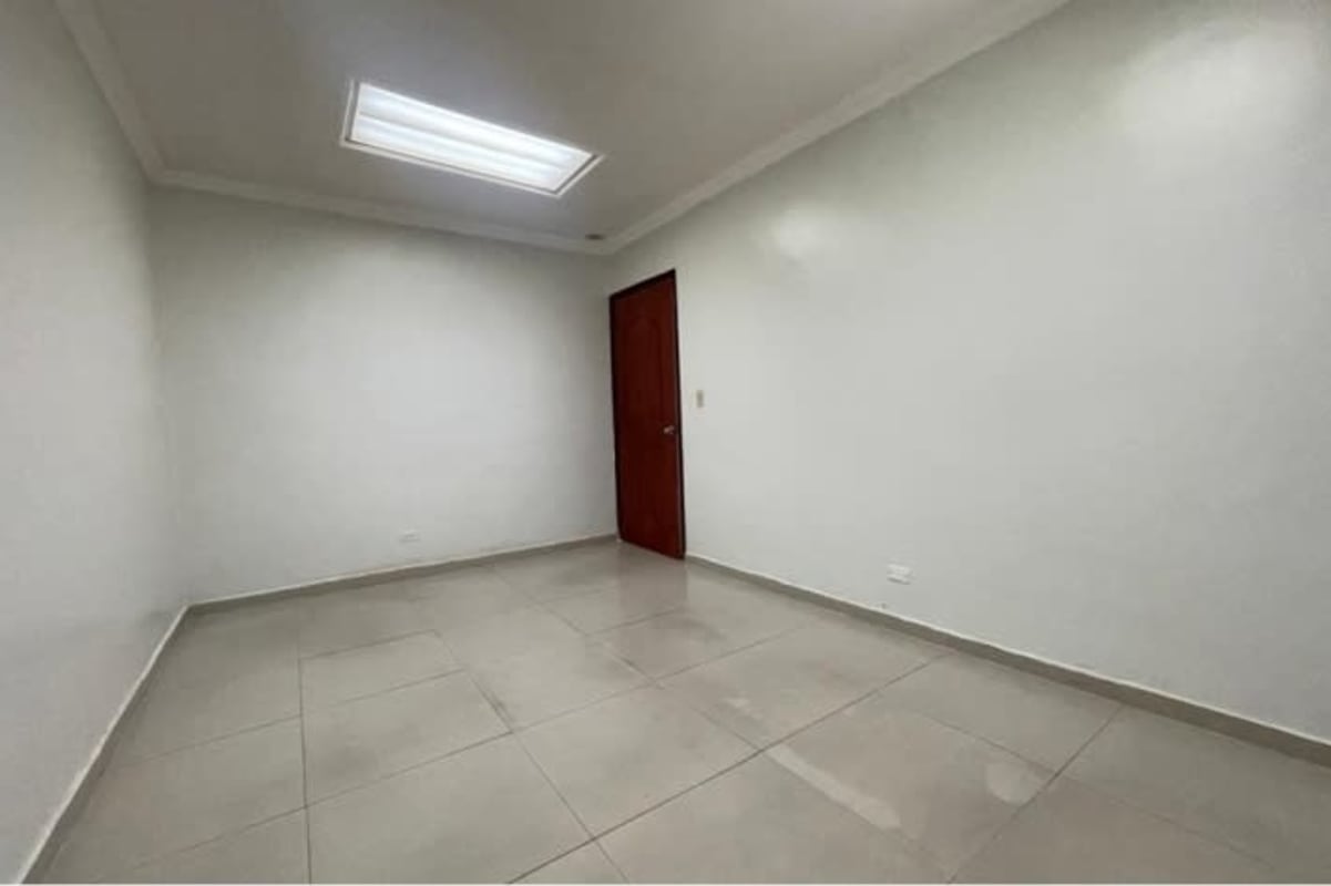 Empty minimalist office space with white walls and tiled floor at PH BICSA Financial Center Panama