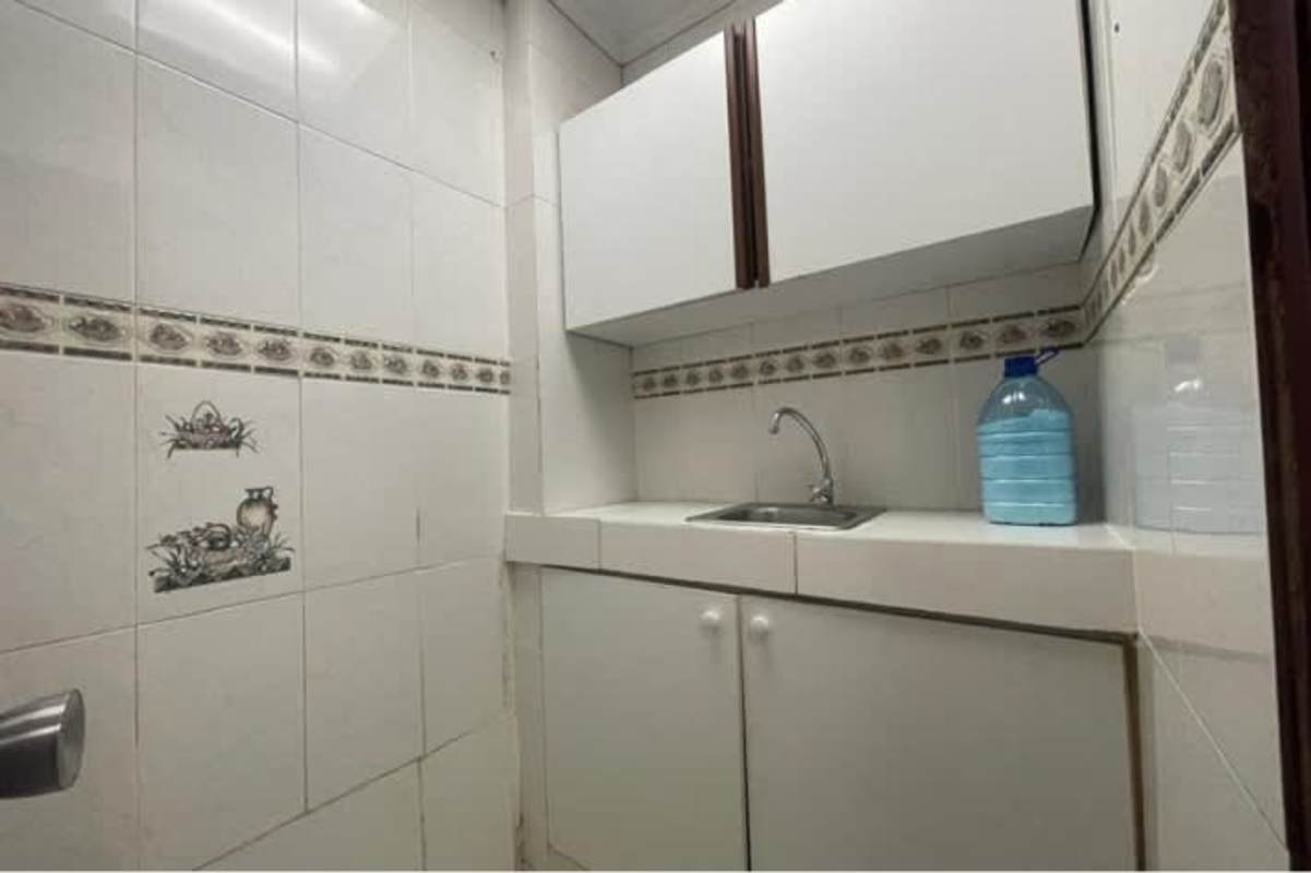 Compact kitchenette area with white cabinets and sink in PH BICSA Tower Panama