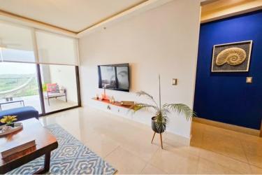 Modern living area with sliding doors to ocean balcony at Royal Pacific Residences Panama