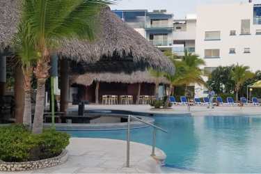 Bright living and dining room fully furnished with pool view Playa Blanca Resort condo Panama