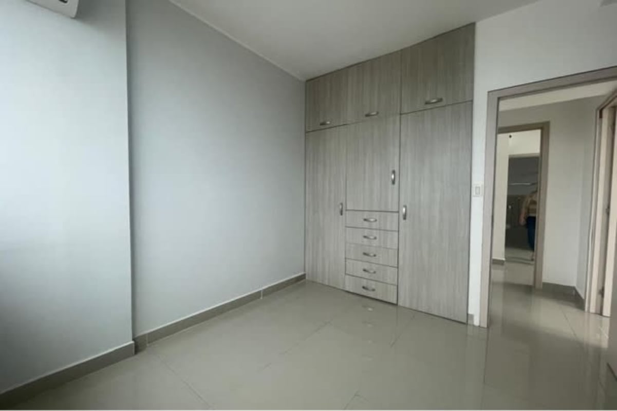 Bedroom with built-in wardrobe, tile floors, AC unit in PH San Francisco Park Panama City