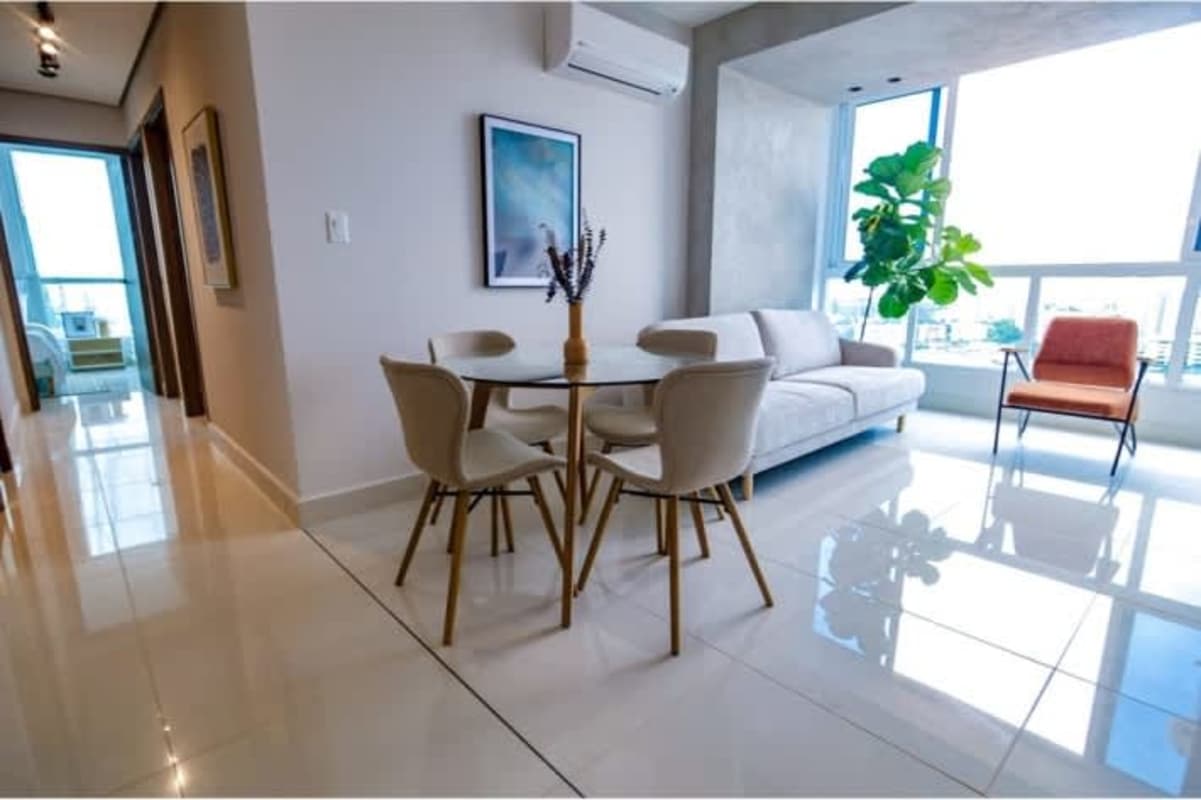 Modern living and dining open layout with large windows in PH Alto Río Panama