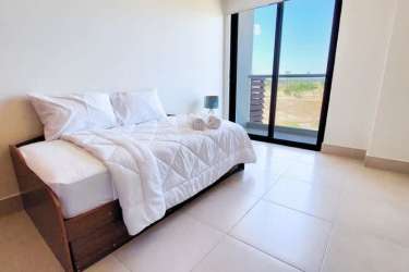 Bright bedroom with sliding doors, balcony access, ocean view at PH Costa Esmeralda Panama