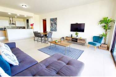 Luxury infinity swimming pool with lounge chairs overlooking Pacific Ocean at Costa Esmeralda