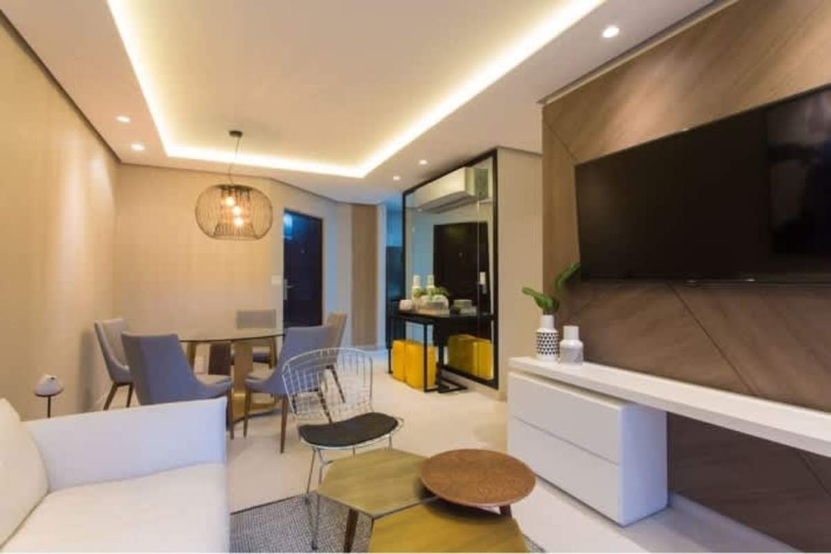 Contemporary kitchen with appliances and stacked laundry space in new condo at Condado Country Club Panama