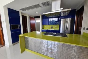 Contemporary open kitchen with island and dining area in River Valley Panama Pacifico apartment