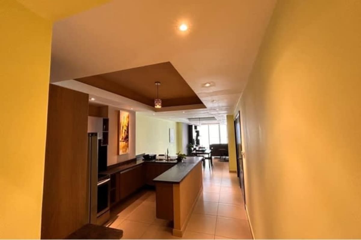 Contemporary kitchen with granite countertops, island, stainless appliances in PH Rivage Avenida Balboa Panama City