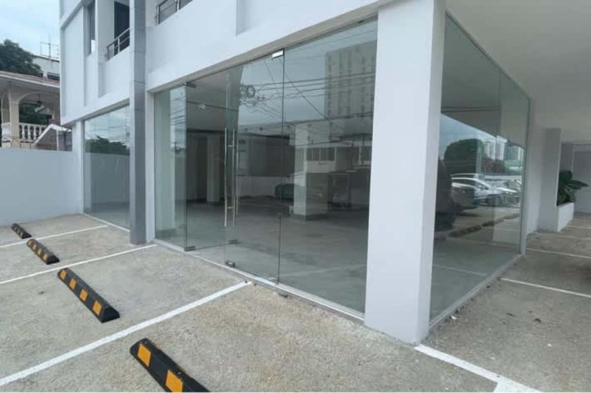 Commercial plaza entrance with glass facade and reserved parking spaces San Francisco Panama