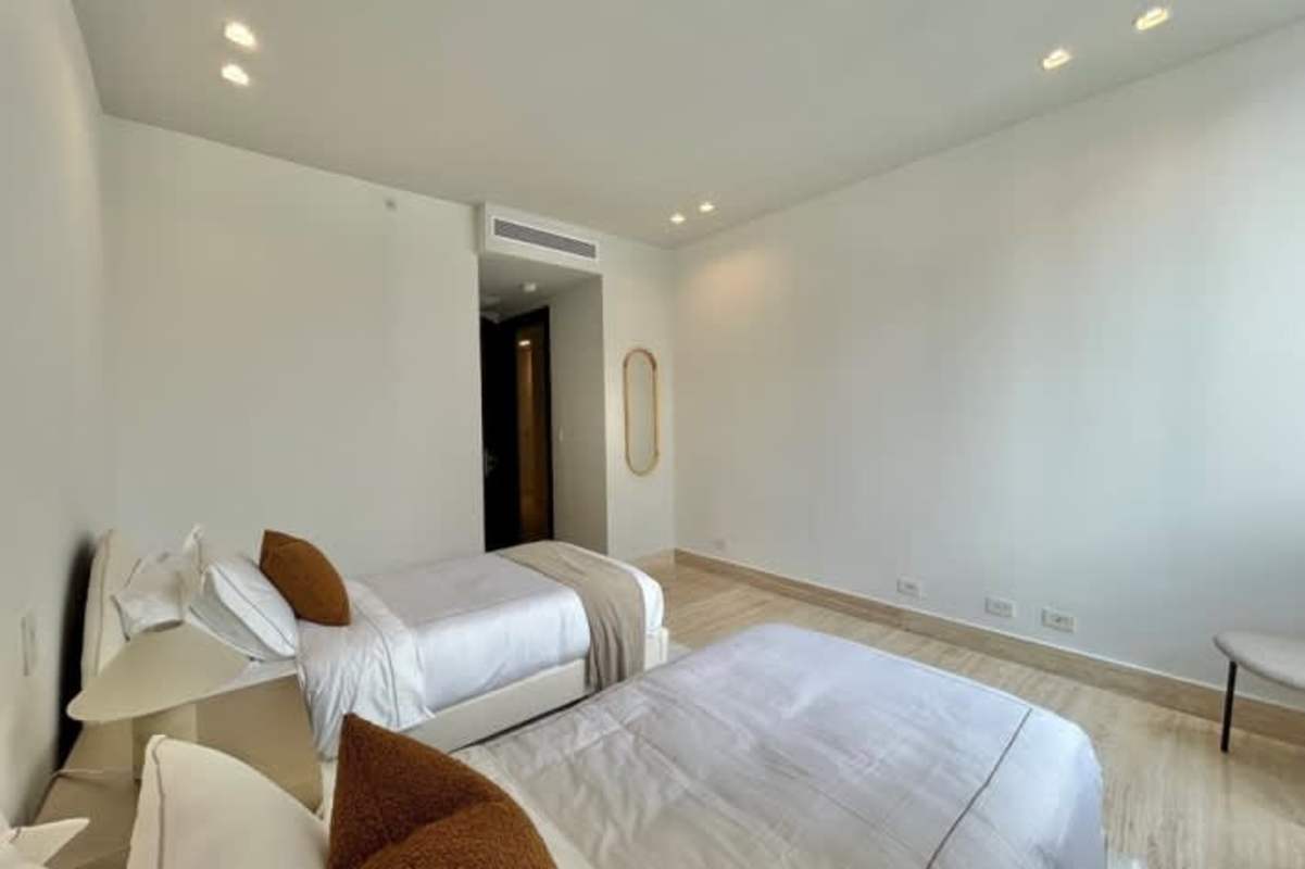 Bright bedroom with modern minimalist decor in luxury apartment Paitilla Panama