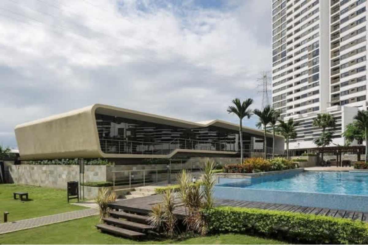 Modern outdoor pool with lounge chairs, pergola, landscaped gardens in PH Condado Country Club Condado del Rey Panama City