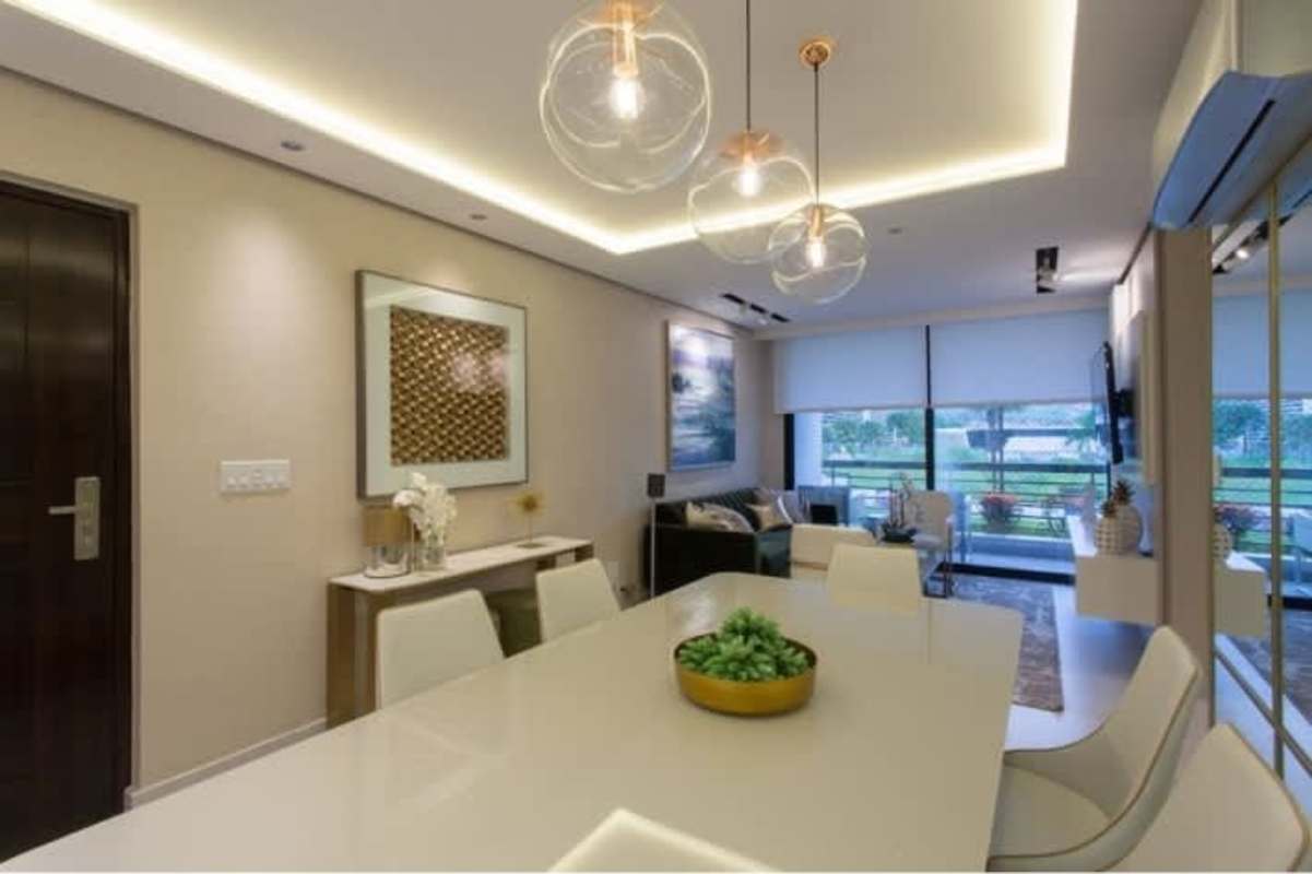 Spacious living and dining area with neutral decor, pendant lights, large windows at Condado del Rey Panama