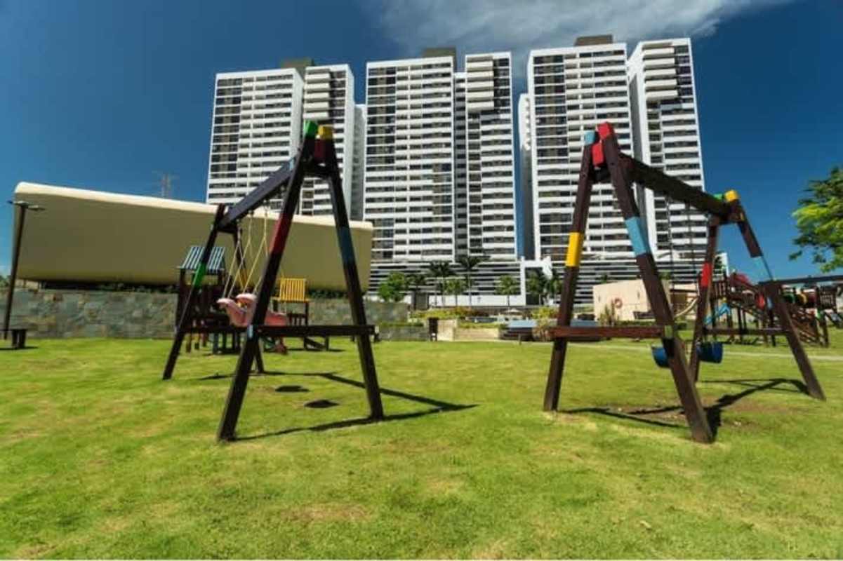 Children's playground, swings, slides in front of towers Condado del Rey Panama