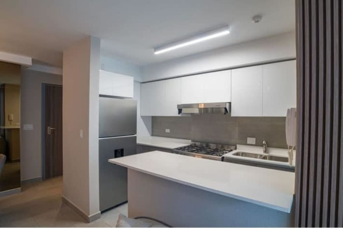Swimming pool with lounge chairs overlooking Panama City skyline in Park Square Via España