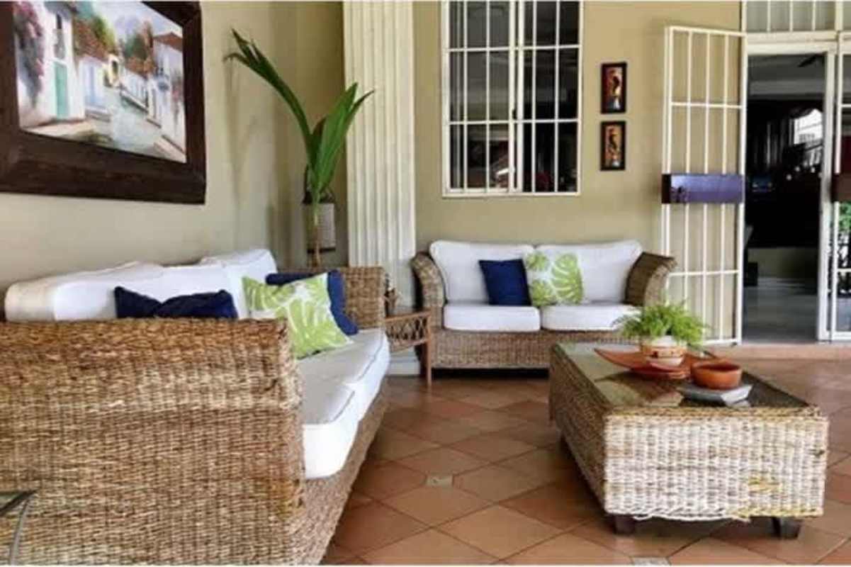 Living and dining area with wicker furniture in duplex Betania Panama